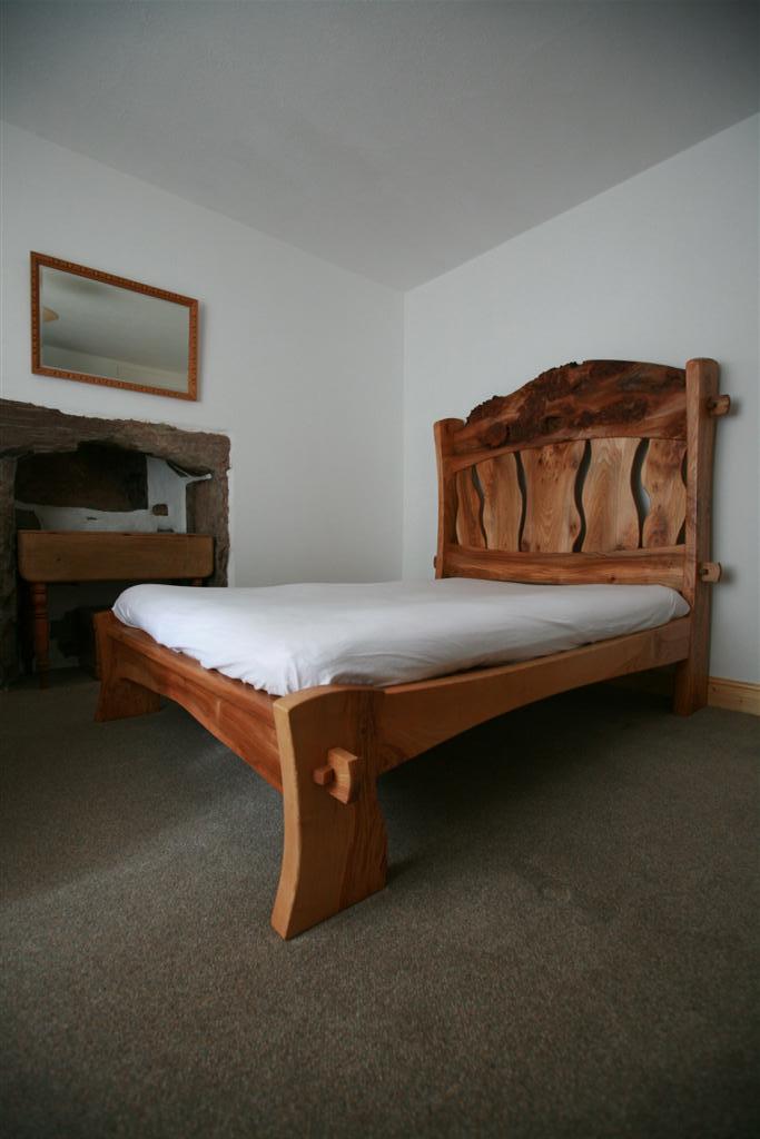 This elm and ash bed has a waney or livedge headboard 